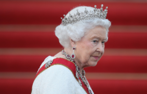 Queen Elizabeth in front of a red backrgound