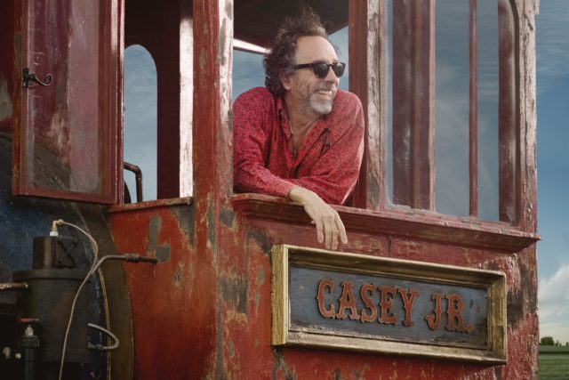 Tim Burton leaning out of a travelling cart