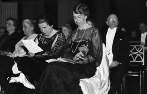 Lorena Hickok sitting beside Eleanor Roosevelt, a man sits behind Eleanor