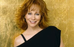 Reba posing in an off-the-shoulder blouse