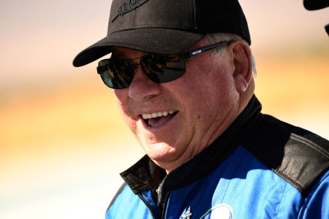 Headshot of William Shatner wearing sunglasses and a hat, smiling