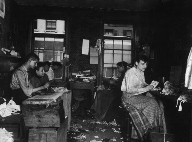 Men and women work in a textile manufacturer tenement operation