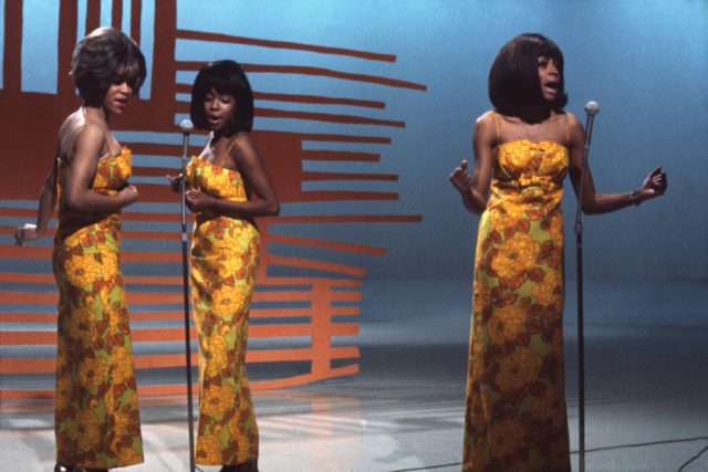 The Supremes performing in yellow dresses