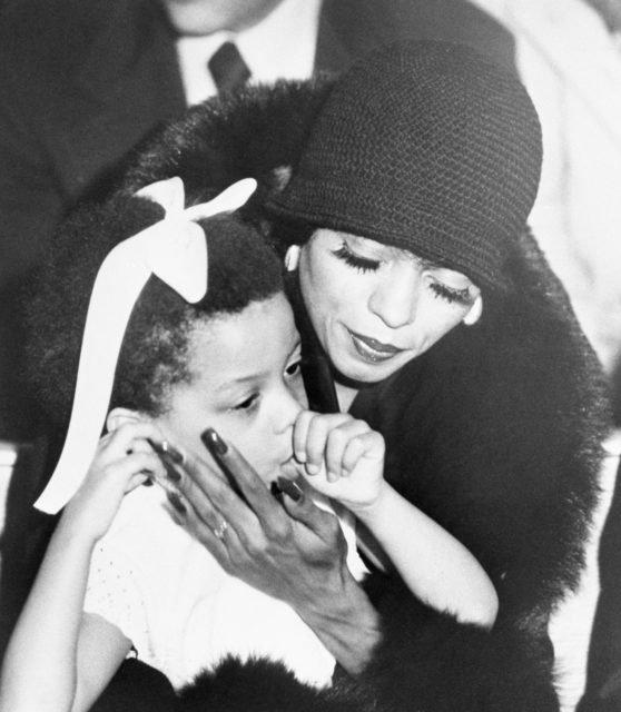 Diana Ross with a child on her lap