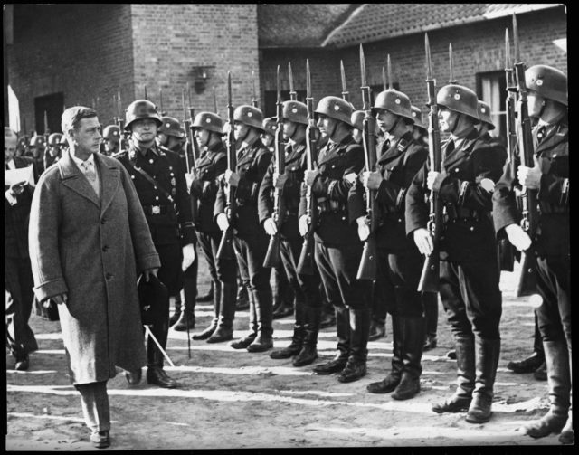 Edward, Duke of Windsor, walking in front of a row of German soldiers