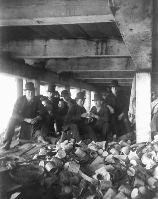 Gang members pose for a photo underneath a pier