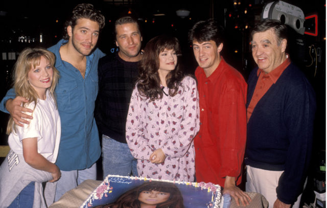 The cast of "Sydney" gathered around a cake