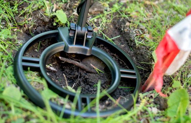 A metal detector near the ground