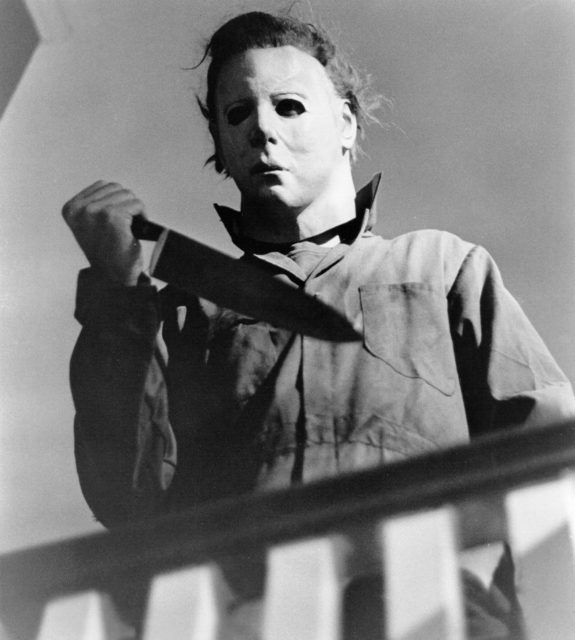 Headshot of character Michael Myers holding a knife