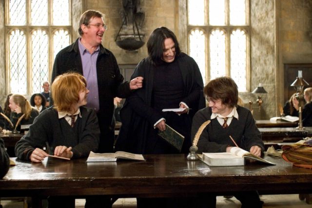 Alan Rickman, Rupert Grint, Daniel Radcliffe and Mike Newell laughing on the set of 'Harry Potter and the Goblet of Fire'