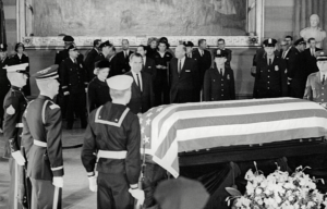 Richard Nixon and others gathered around JFK's casket