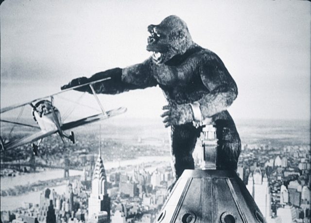 King kong on a building with a plane