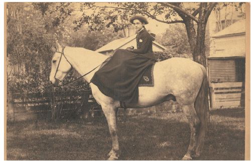 A girl on a horse in an old timey photo