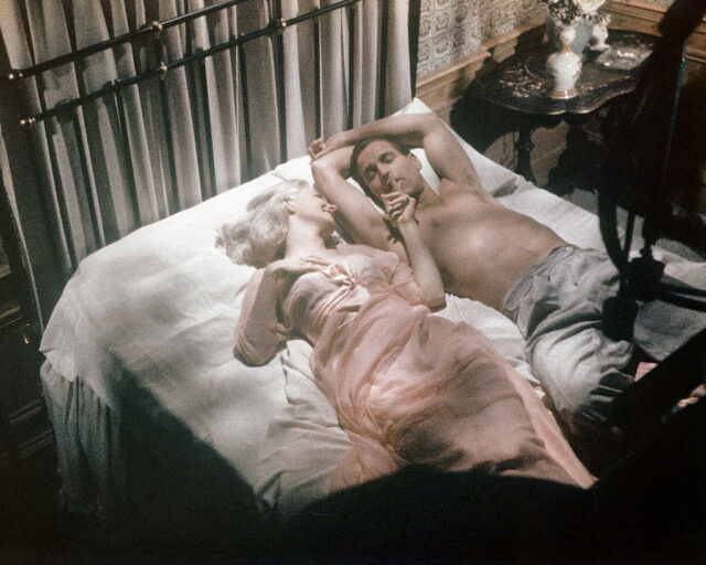Paul Newman and Joanne Woodward in bed together while shooting a scene from 'From The Terrace' in 1960