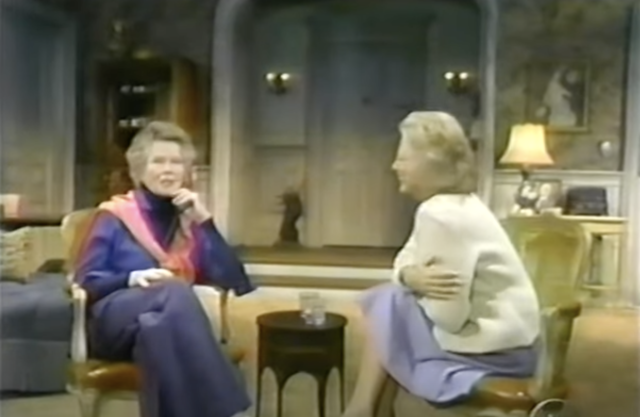 Katharine Hepburn sits across from Barbara Walters in a room for an interview with a table between them