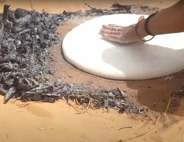 Ash cake spread over hot sand