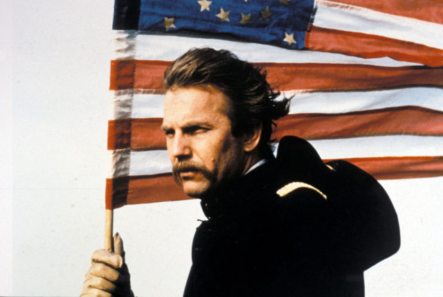 Kevin Costner holding an American Flag