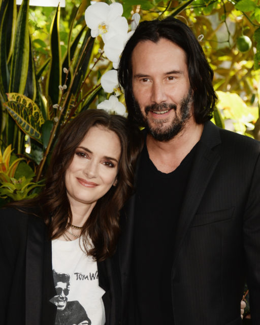 Headshot of Winona Ryder and Keanu Reeves side-hugging