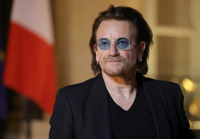 Bono wearing sunglasses indoors