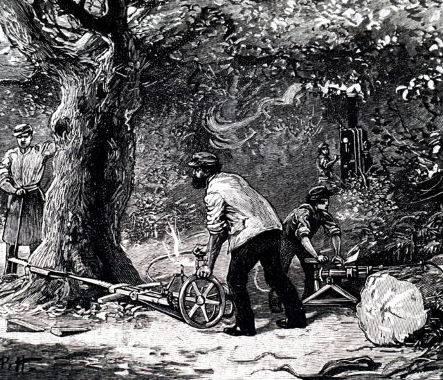 A drawing depicts men using a steam powered chainsaw
