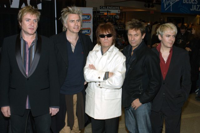 The band, Duran Duran, standing in line