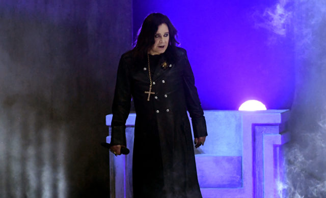 Ozzy Osbourne in a cape and walking on stage