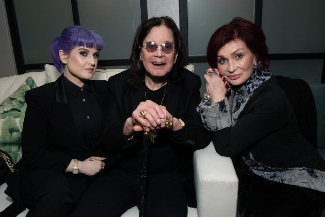 Ozzy Osbourne with his daughter and wife on either side of him sitting