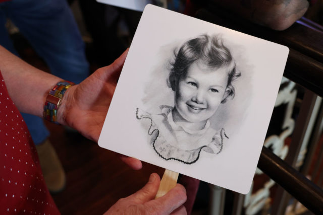 A photo of Naomi Judd as a child on a memorial fan 