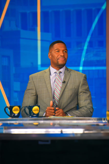 Michael Strahan sitting at a desk on "Good Morning America"