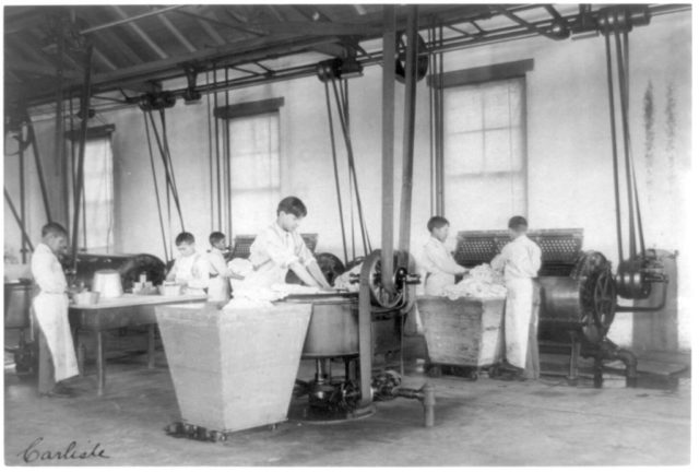 Native students do laundry at an Indian School