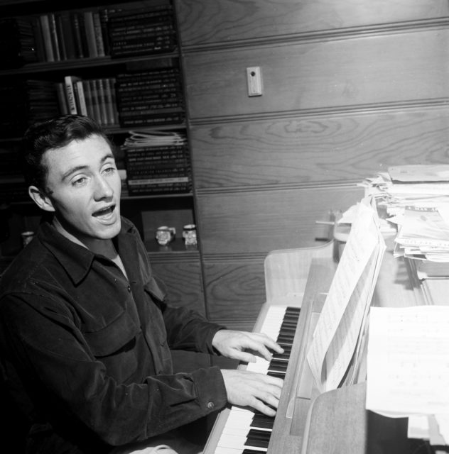 Merv Griffin singing and playing the piano