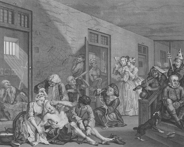 Etching shows an 18th century mental asylum