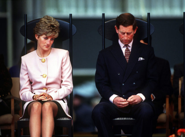 Princess Diana and Prince Charles sitting side-by-side, unhappy.