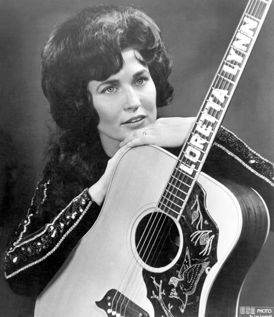 Photo of Loretta Lynn with custom guitar