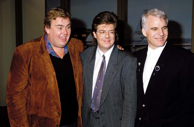 John Candy, John Hughes, and Steve Martin posing for a photo