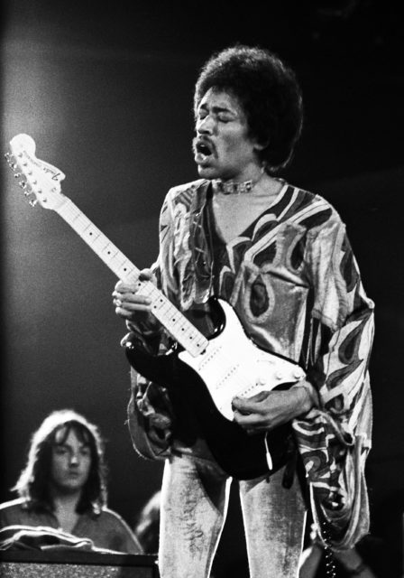 Jimi Hendrix on stage playing the electric guitar