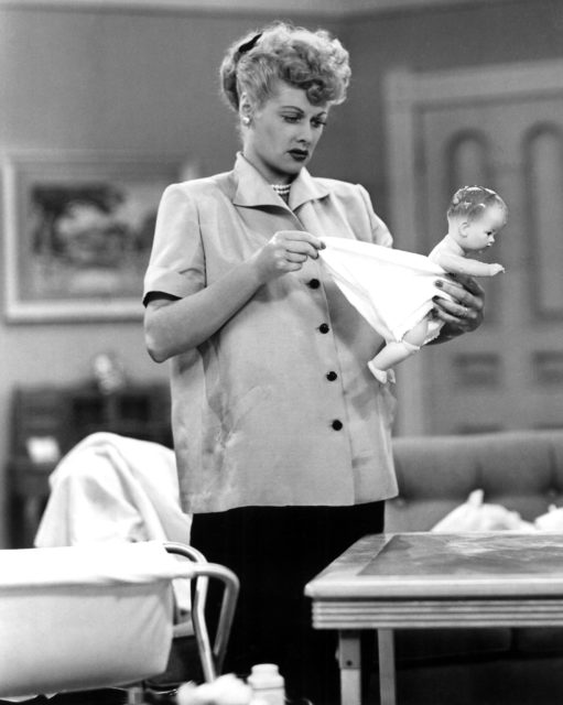 Lucille Ball as Lucy Ricardo, holding a baby doll