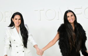 Posed photo of Rumer Willis and Demi Moore holding hands