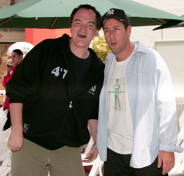 Quentin Tarantino and Adam Sandler posing for a photo together.