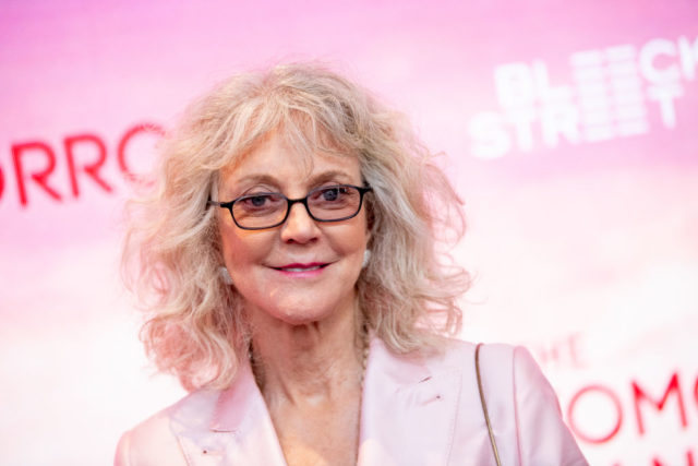Blythe Danner in front of a pink wall