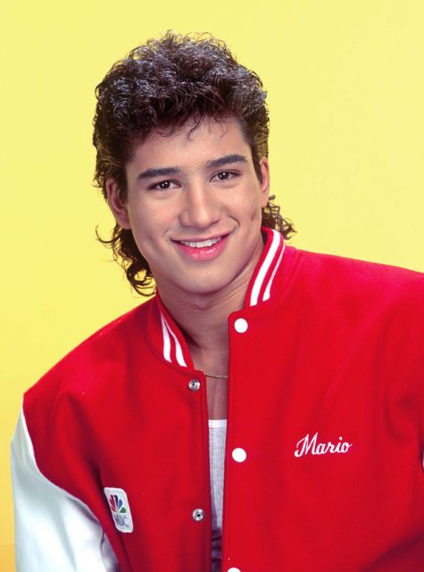 Portrait of Mario Lopez in a red varsity jacket
