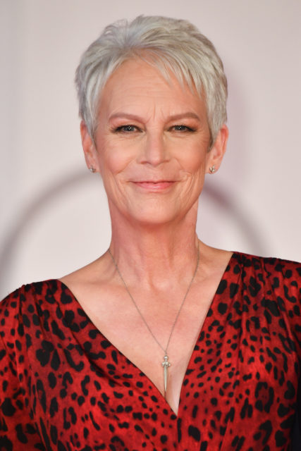 Jamie Lee Curtis standing on a red carpet