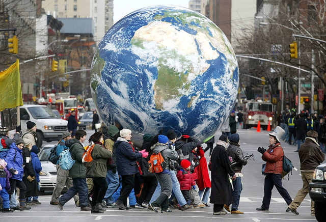 Protesters carrying a model of planet Earth