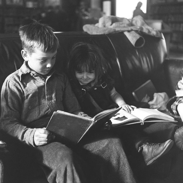 children reading at the library in 1947