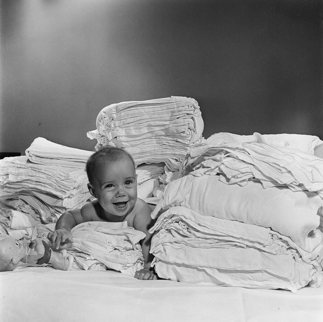 a baby on a stack of diapers