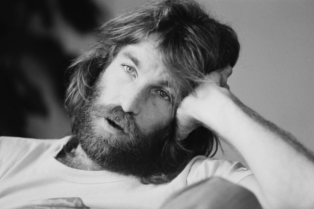 Headshot of Dennis Wilson with his head in his hand