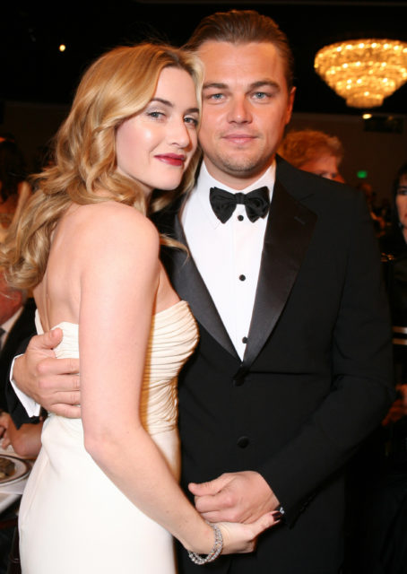 Headshot of Leonardo DiCaprio and Kate Winslet dressed well and hugging