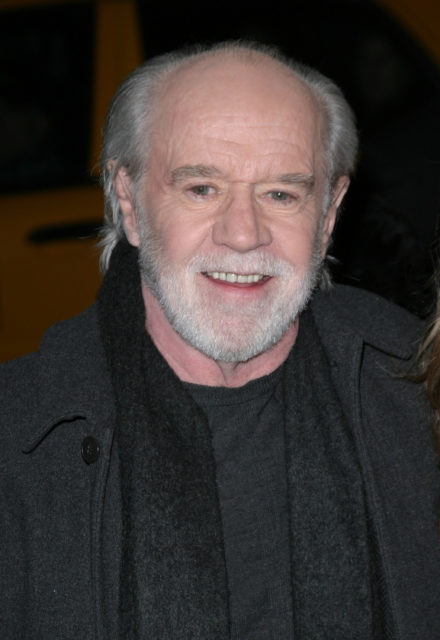 George Carlin in a black shirt