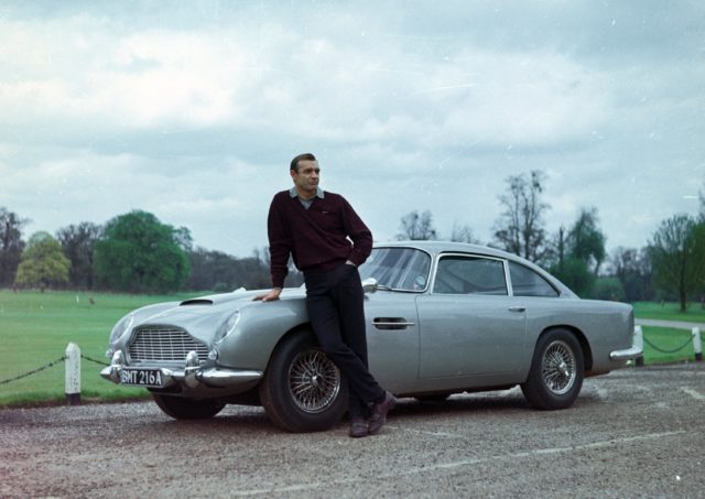 Sean Connery as James Bond leading against a sports car.