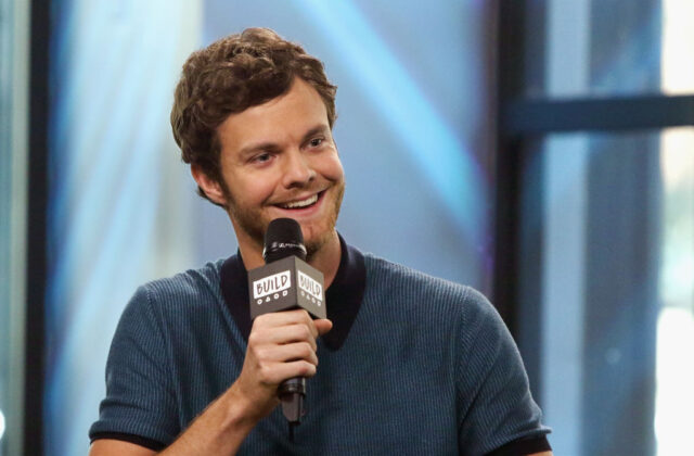 Jack Quaid speaking into a microphone